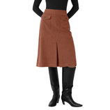 A rust-colored, knee-length skirt with front pockets and a center slit, paired with a black long-sleeve top and knee-high black boots.