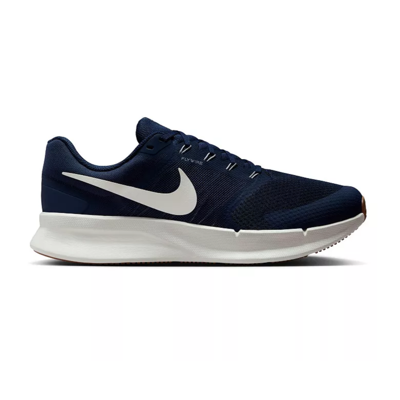 A dark blue running shoe with a white swoosh logo and a white sole, featuring Flywire technology for support.