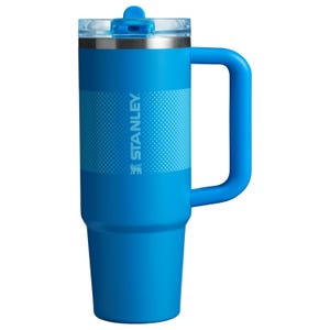 Blue Stanley insulated mug with a lid and handle.