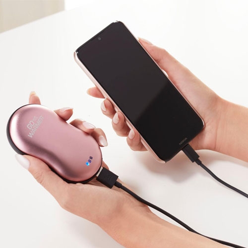 a pink electric hand warmer plugged into a smartphone