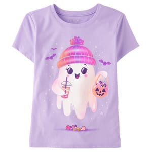 Lavender t-shirt featuring a cute ghost wearing a beanie, holding a drink, and a pumpkin basket filled with candy. Surrounded by bats, sparkles, and additional candy at the bottom.