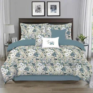 A floral-patterned comforter set on a bed, featuring teal and white flowers with matching pillows. The room includes two side tables with lamps and framed art above the headboard.