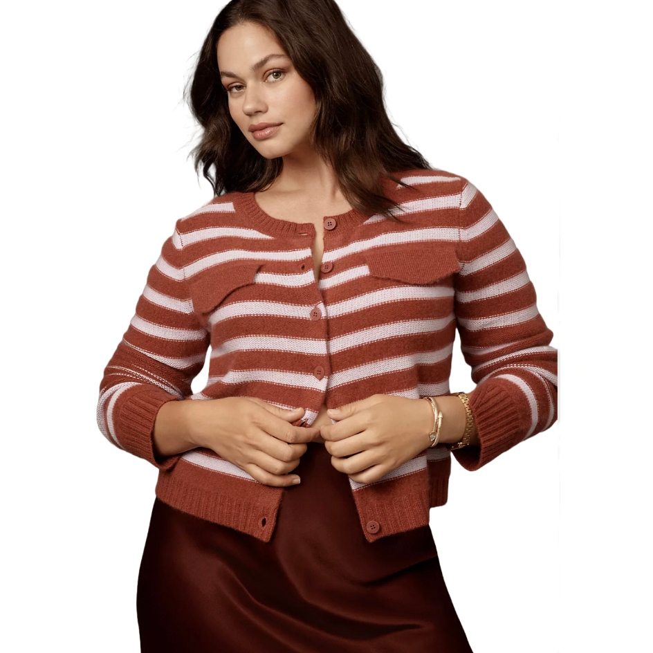 A striped cashmere sweater in rust and white with a round neckline, button-up front, and long sleeves. It's paired with a chocolate-brown satin skirt.