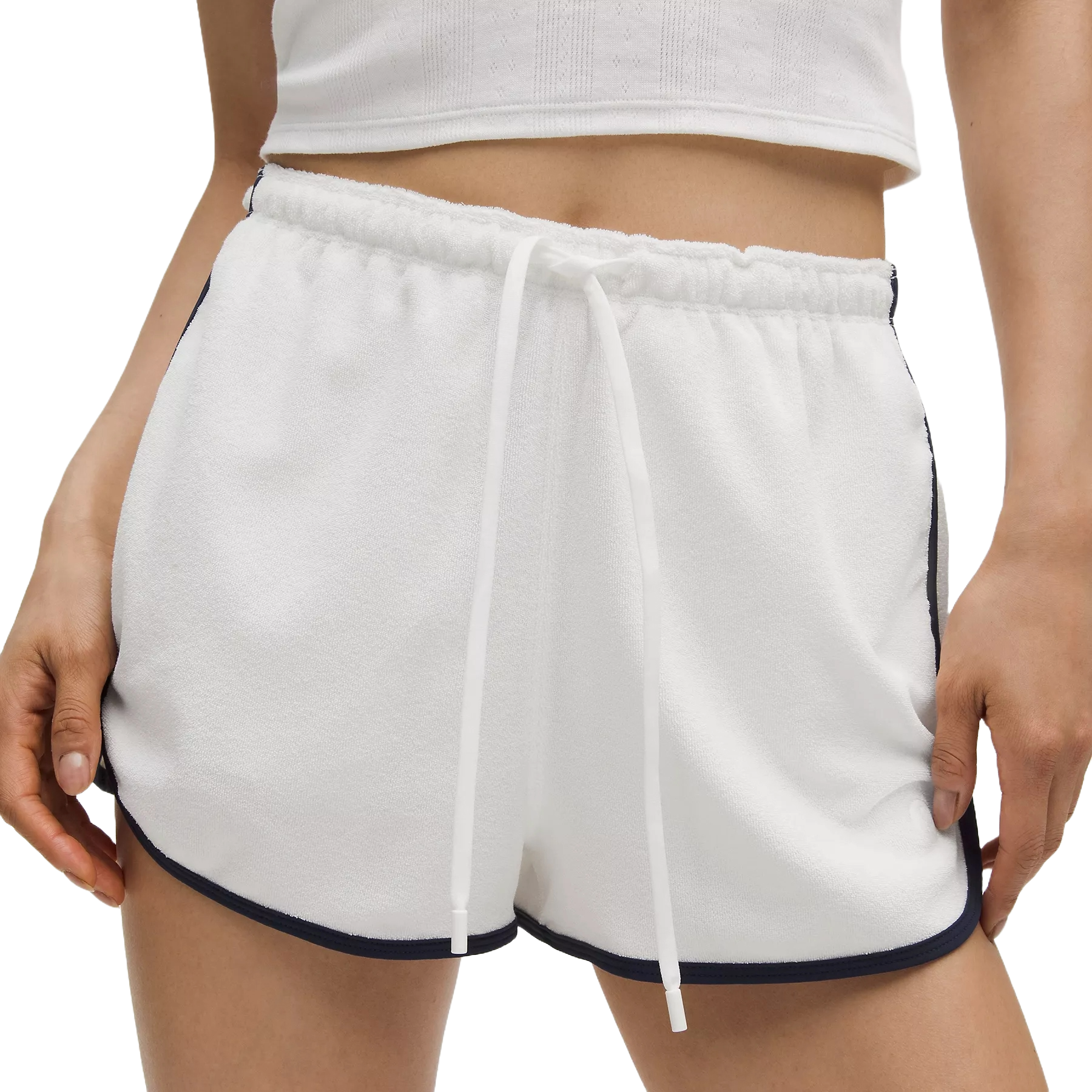 White lululemon Cotton Terry Slim-Fit Shorts with a drawstring waistband, featuring black trim along the sides and hem, paired with a white cropped top.