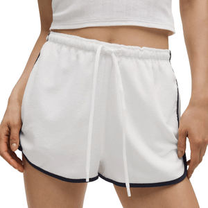 White lululemon Cotton Terry Slim-Fit Shorts with a drawstring waistband, featuring black trim along the sides and hem, paired with a white cropped top.