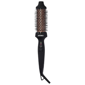 The Amika Blowout Round Brush Dryer features a black handle with an ion switch and an orange ceramic barrel with nylon bristles, designed to dry and style hair simultaneously.