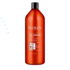 Redken Frizz Dismiss Shampoo with Babassu oil, 1000 ml bottle, designed for anti-frizz and smoothing benefits for unmanageable hair.