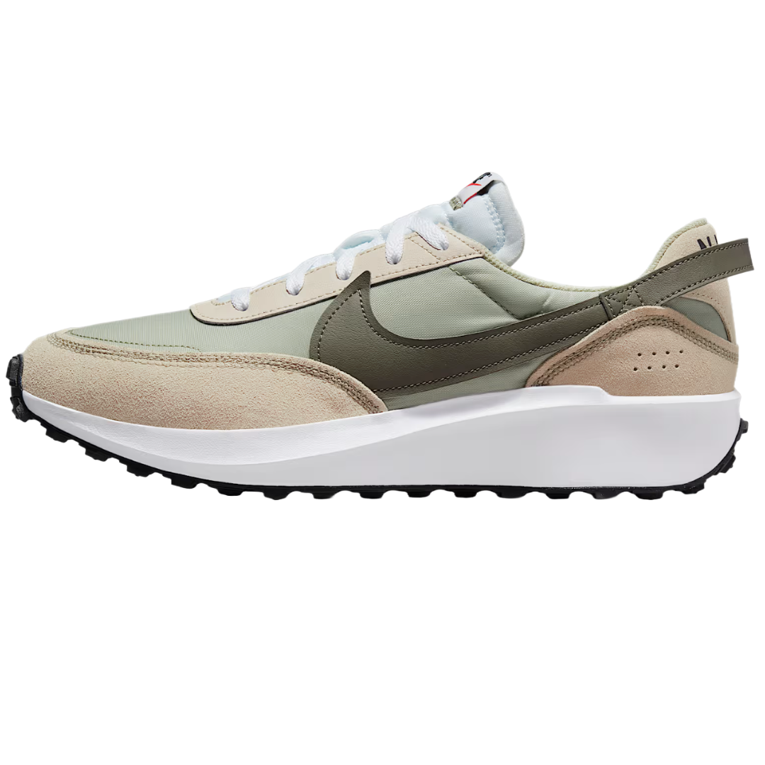 A sneaker with a mix of beige suede and olive green fabric, featuring a white midsole, black outsole, and a prominent swoosh logo on the side.