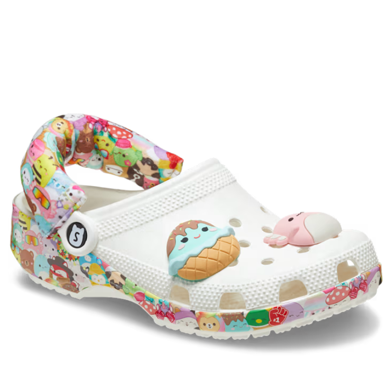 Squishmallows Crocs feature a white base with colorful character prints on the strap and sole, adorned with 3D ice cream and whale charms on the vamp.