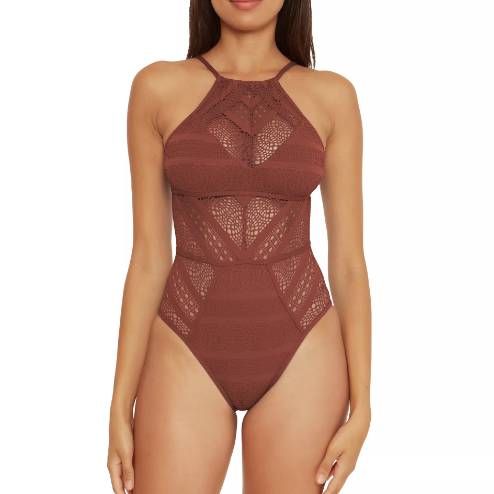 A woman is wearing a brown lace halterneck bodysuit.