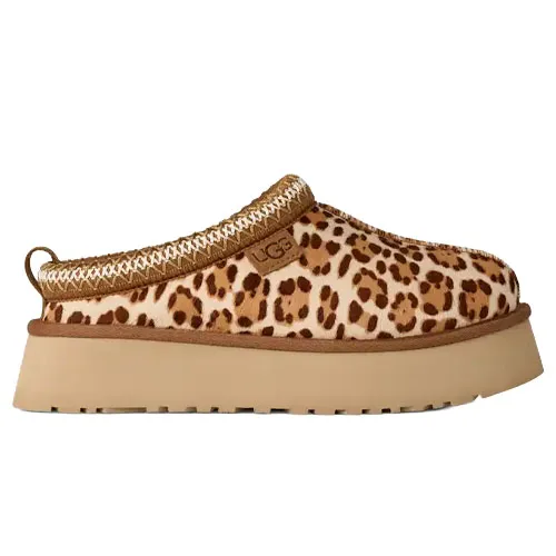 A leopard print UGG slipper with a thick beige platform sole and a decorative woven trim.