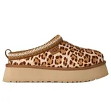 A leopard print UGG slipper with a thick beige platform sole and a decorative woven trim.