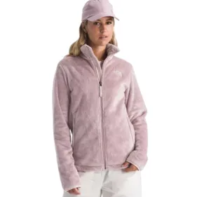 A person is wearing a light pink fleece jacket with a full zip and white pants, complemented by a matching pink cap.