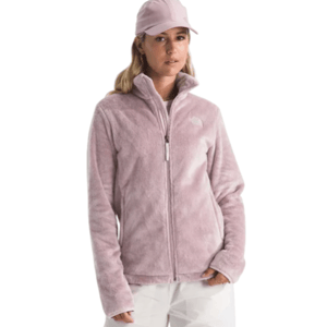A person is wearing a light pink fleece jacket with a full zip and white pants, complemented by a matching pink cap.