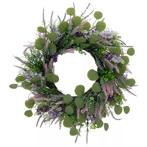 A round wreath featuring a mix of artificial greenery with eucalyptus leaves, purple flowers, and lavender accents, creating a lush, natural appearance.