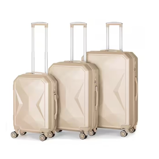 Three beige hard-shell suitcases with four wheels and telescopic handles, varying in size.