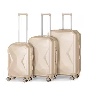 Three beige hard-shell suitcases with four wheels and telescopic handles, varying in size.