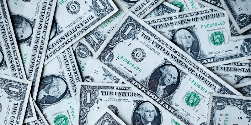 A pile of one dollar American bills. 