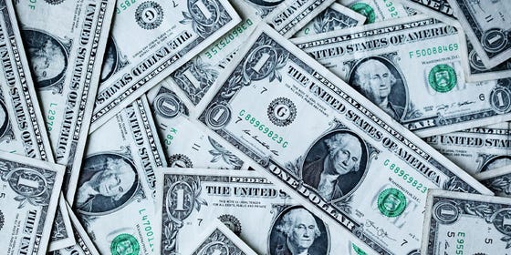 A pile of one dollar American bills.