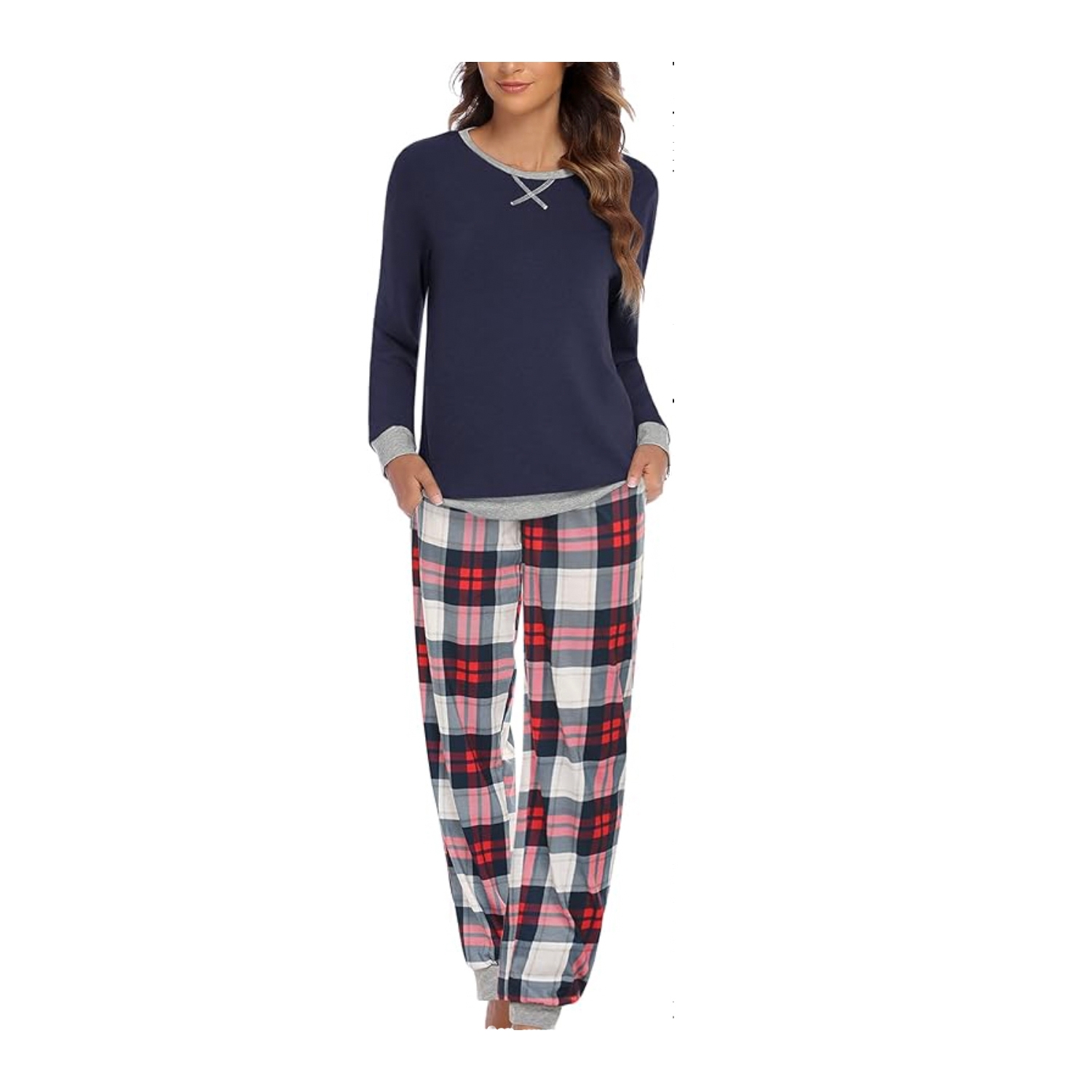 Woman wearing a navy blue long-sleeve pajama top with lace-up detail at the neck and gray cuffs, paired with plaid pajama pants in red, gray, and white.