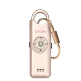 A gold-colored personal safety alarm with the word \“birdie\“ on it, featuring a loop for attachment, a prominent button, and a small speaker grill.