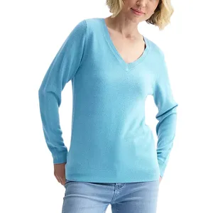 A person is wearing a light blue V-neck sweater with long sleeves and light denim jeans.