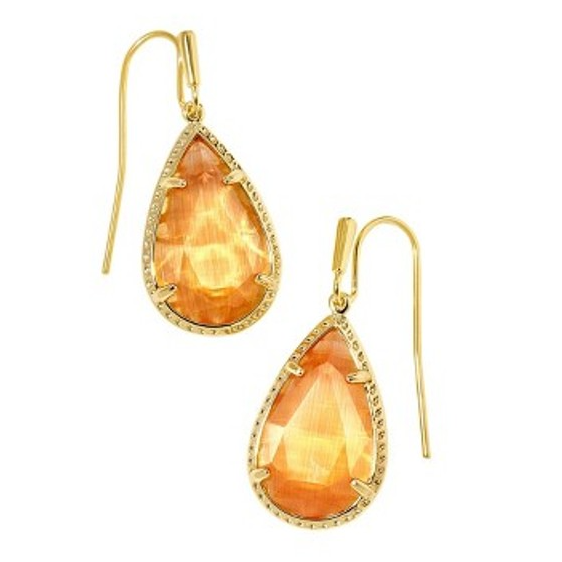 Gold drop earrings with pear-shaped orange gemstones, set in a detailed gold prong setting, featuring hook-style clasps.