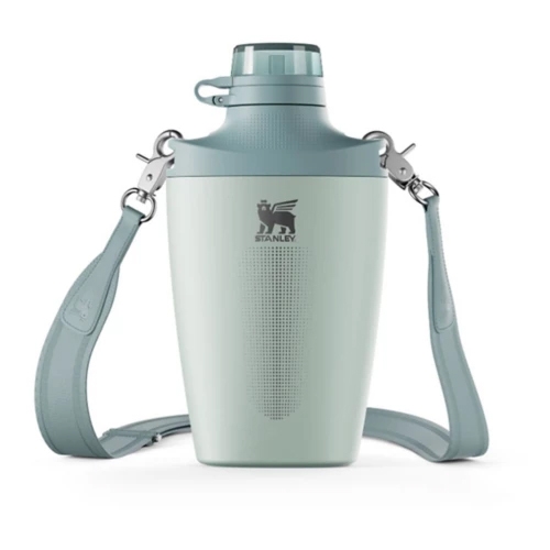A light blue Stanley growler with a wide-mouth lid and a detachable shoulder strap for easy carrying.