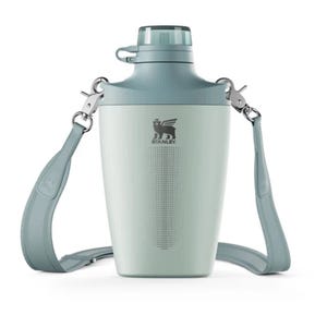 A light blue Stanley growler with a wide-mouth lid and a detachable shoulder strap for easy carrying.