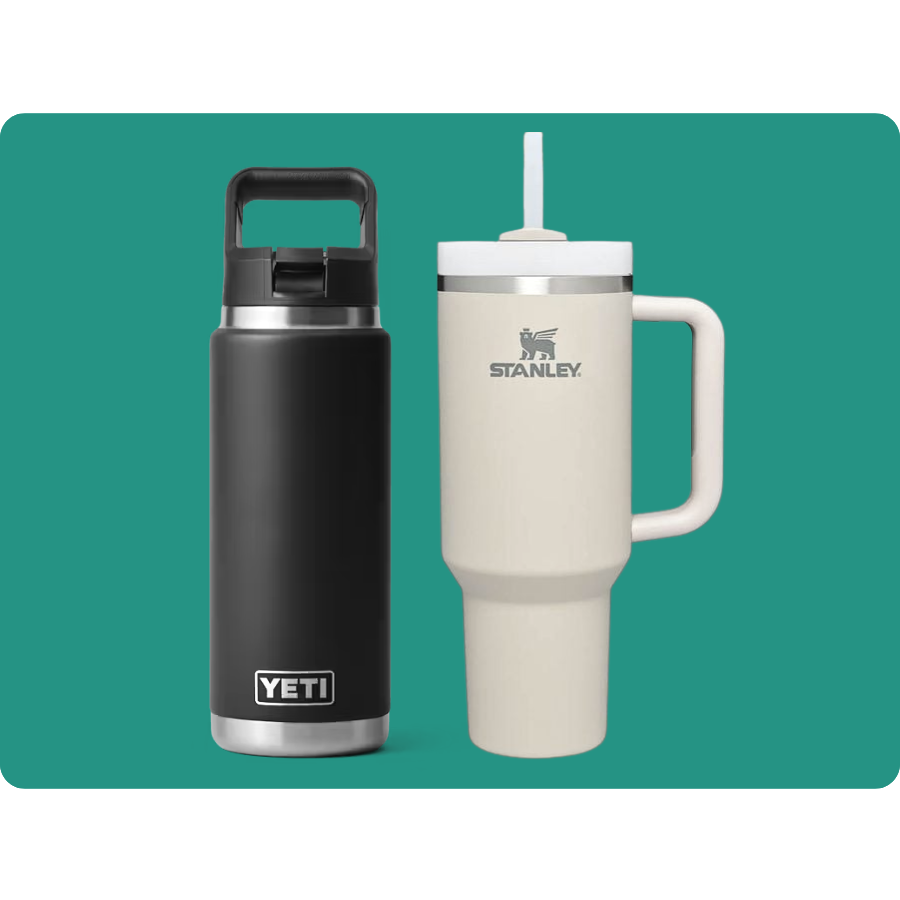 A black YETI bottle with a handle and a cream-colored Stanley cup with a straw and handle are shown side by side.