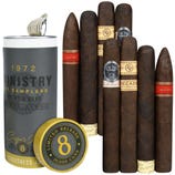 A sample pack of cigars next to a can labeled \“1972 Ministry of Samplers,\“ featuring various dark-wrapped cigars with bands including \“Cain,\“ \“Oliva,\“ and \“Decade.\“