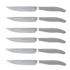 A set of six stainless steel steak knives with serrated blades, featuring sleek, modern handles.