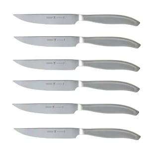 A set of six stainless steel steak knives with serrated blades, featuring sleek, modern handles.