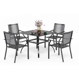 A set of four steel patio chairs with a matching square table, all in a sleek dark color, arranged with a floral centerpiece and tableware.