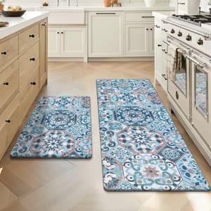 Kitchen features two patterned floor mats with blue and beige geometric and floral designs, placed in front of a stove and sink.