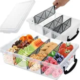 A transparent storage box with adjustable dividers features compartments filled with various fruits, cookies, and dried snacks, accompanied by a removable lid and black handle.