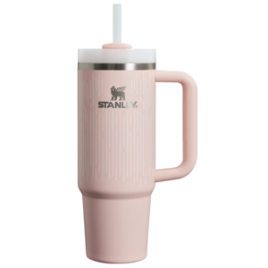 A pink Stanley insulated tumbler with a lid, straw, and handle, designed for hot or cold beverages.