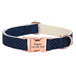 Adjustable pet collar with a blue patterned fabric, featuring a rose gold metal buckle engraved with the name \“Piper\“ and a phone number.