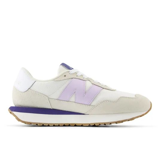 Cream and purple New Balance sneaker with a suede toe, gum sole, and the brand's signature \“N\“ logo on the side.