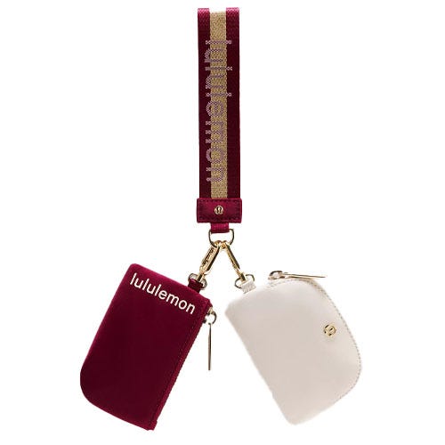 A maroon and white Lululemon wrist strap with two attached zippered pouches.