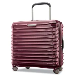 A burgundy hard-shell suitcase with a ribbed design, telescopic handle, and four spinner wheels.