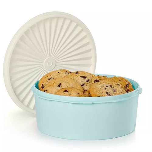 Tupperware Heritage Cookie Canister features a round, light blue container with a white, starburst-patterned lid, holding chocolate chip cookies.