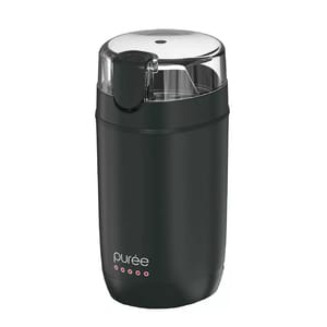 A black electric coffee grinder with a transparent lid and a modern, cylindrical design. It features the brand name \“purée\“ and a simple push-button operation for grinding beans.
