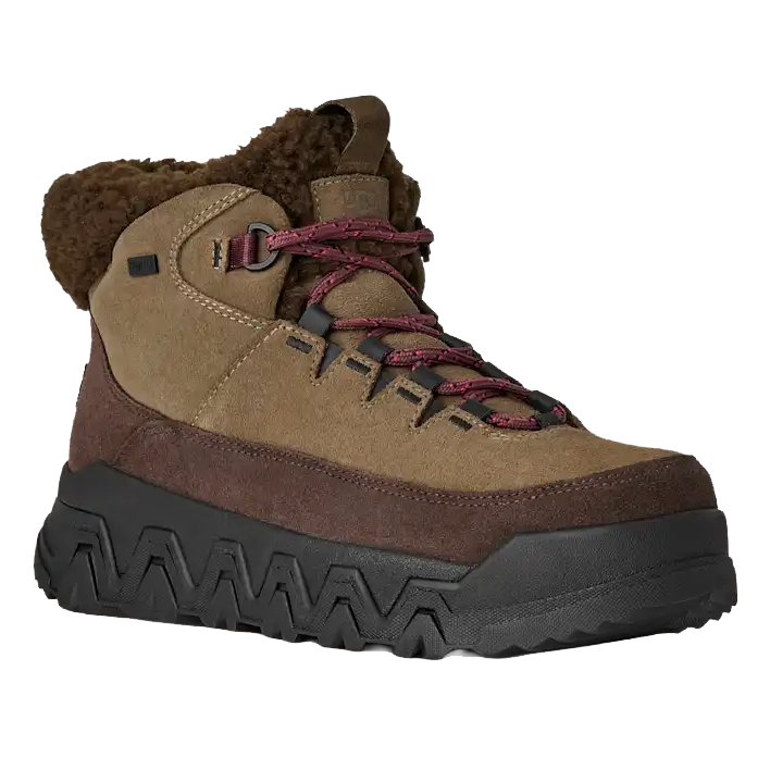 A brown and tan hiking boot with a thick black sole, featuring red laces and a shearling collar for added warmth and comfort.