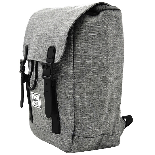 Gray backpack with a flap top, black buckle straps, and a subtle textured design. Features a front logo patch and a top handle for easy carrying.
