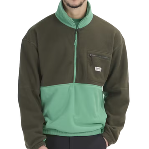 The Marmot Retro Rocklin Jacket features a two-tone design with dark green on the top and mint green on the lower half, a half-zip front, and a small zippered chest pocket with a Marmot logo patch.