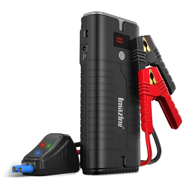 A black portable jump starter power bank with attached red and black jumper cables and an LED display showing 100%. It features multiple ports and a compact design, suitable for emergency car start-ups.