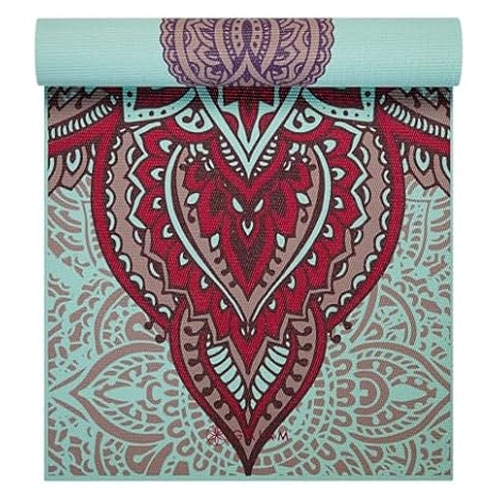 A turquoise yoga mat with intricate red and purple mandala patterns.