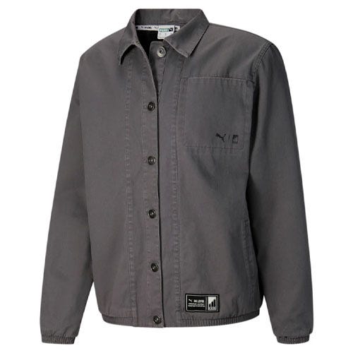 A gray Puma x Cordae shirt jacket featuring button closure, a chest pocket with branding, and adjustable cuffs. It also has a label at the hem and a collared neck design.