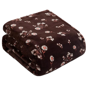 A dark brown throw with a daisy floral pattern, featuring white daisies with pink centers scattered throughout.